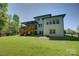 Rear exterior view of the home featuring a multi-level deck, numerous windows, and well-kept lawn at 1306 Kings Bottom Dr, Fort Mill, SC 29715