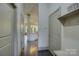 Hallway with hardwood floors leading to a modern kitchen with plenty of storage space at 1306 Kings Bottom Dr, Fort Mill, SC 29715