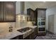 Close up of the chef's kitchen with stainless steel appliances, granite countertops, and custom tile backsplash at 1306 Kings Bottom Dr, Fort Mill, SC 29715