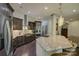 Gourmet kitchen with stainless steel appliances, custom cabinetry, granite countertops, and an expansive center island at 1306 Kings Bottom Dr, Fort Mill, SC 29715