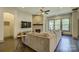 Inviting living room features a fireplace, ceiling fan and large windows overlooking lush greenery at 1306 Kings Bottom Dr, Fort Mill, SC 29715