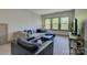 Bright living room featuring a large sectional sofa, a black chair, and natural light from three large windows at 1306 Kings Bottom Dr, Fort Mill, SC 29715