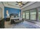 Beautiful primary bedroom showcasing a decorative accent wall, tray ceiling and large windows at 1306 Kings Bottom Dr, Fort Mill, SC 29715