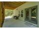 Covered patio with outdoor seating, view of the backyard, and access through double doors and a window at 1306 Kings Bottom Dr, Fort Mill, SC 29715