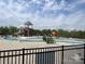Community pool area featuring a water slide, mushroom fountains, and bridge walkways for Gathering fun at 1306 Kings Bottom Dr, Fort Mill, SC 29715