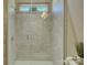 Contemporary shower enclosed in glass features light tile walls, modern fixture and sunlight at 1306 Kings Bottom Dr, Fort Mill, SC 29715