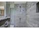 A glass enclosed shower with tiled walls features modern fixtures and ample natural light at 1306 Kings Bottom Dr, Fort Mill, SC 29715