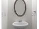 Elegant half-bathroom with oval mirror and white vessel sink at 133 Capital Ave # B, Mooresville, NC 28117