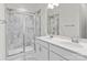 Modern bathroom with double sink vanity, large mirror, and glass-enclosed shower at 133 Capital Ave # B, Mooresville, NC 28117