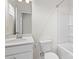 Bright bathroom featuring a vanity, toilet, and a tub with shower, all in a clean white color scheme at 133 Capital Ave # B, Mooresville, NC 28117