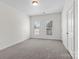 Inviting bedroom with two windows and neutral carpet at 133 Capital Ave # B, Mooresville, NC 28117