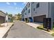 Townhome exterior showing private garages, mailboxes, trash receptacles, and landscaping at 133 Capital Ave # B, Mooresville, NC 28117