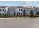 Charming townhomes feature manicured landscaping, metal fences, and inviting entryways at 133 Capital Ave # B, Mooresville, NC 28117