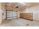 Spacious garage with unfinished drywall, wooden shelving, and a white garage door at 133 Capital Ave # B, Mooresville, NC 28117