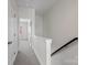 Bright hallway with neutral carpet and white trim at 133 Capital Ave # B, Mooresville, NC 28117