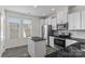 Modern kitchen featuring stainless steel appliances, granite counters, and ample lighting at 133 Capital Ave # B, Mooresville, NC 28117