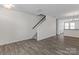 Bright living room featuring sleek flooring and modern staircase design at 133 Capital Ave # B, Mooresville, NC 28117