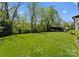 Expansive backyard featuring lush green lawn and a charming outdoor living area at 1446 Townes Rd, Charlotte, NC 28209
