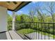 Balcony with black iron railing overlooking a lush green backyard, perfect for relaxing outdoors at 1446 Townes Rd, Charlotte, NC 28209