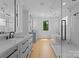 Bright, modern bathroom featuring double vanity, soaking tub, and glass-enclosed shower at 1446 Townes Rd, Charlotte, NC 28209