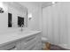 Modern bathroom featuring a vanity, toilet, and shower with curtain at 1446 Townes Rd, Charlotte, NC 28209