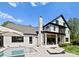 Stunning exterior view of a two-story home with a pool, outdoor living spaces, and manicured lawn at 1446 Townes Rd, Charlotte, NC 28209