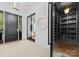 Stylish entryway with a clear view of a wine cellar, modern decor, and glass doors at 1446 Townes Rd, Charlotte, NC 28209