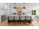 Stylish kitchen showcases a central island with barstool seating, modern lighting and open design at 1446 Townes Rd, Charlotte, NC 28209