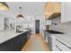 Bright kitchen features stainless steel appliances, center island with sink, and designer fixtures at 1446 Townes Rd, Charlotte, NC 28209