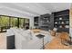 Spacious living room with a cozy fireplace, built-in shelves, and access to the patio at 1446 Townes Rd, Charlotte, NC 28209