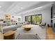 Expansive living room with a modern sectional sofa, and direct access to an outdoor patio at 1446 Townes Rd, Charlotte, NC 28209