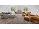 Spacious living room with plush seating, large windows, and natural light at 1446 Townes Rd, Charlotte, NC 28209