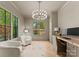 Comfortable office with natural light, hardwood floors, a chandelier and custom built-ins at 1446 Townes Rd, Charlotte, NC 28209