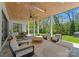 Covered patio has an outdoor living area and dining space with views of the lawn at 1446 Townes Rd, Charlotte, NC 28209