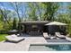 View of the pool and poolside cabana with outdoor kitchen and seating at 1446 Townes Rd, Charlotte, NC 28209