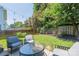 Inviting backyard patio with modern seating, string lights, and privacy fence at 1529 Briar Creek Rd # 1A, Charlotte, NC 28205