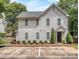 Charming two-story home with vertical siding, and manicured landscaping at 1529 Briar Creek Rd # 1A, Charlotte, NC 28205