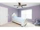 Cozy bedroom with soothing lavender walls, a white bed, and a window creating a peaceful retreat at 1540 Coatsworth Ln, Rock Hill, SC 29732