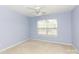 Blue bedroom with a ceiling fan and a bright window covered by blinds at 1540 Coatsworth Ln, Rock Hill, SC 29732