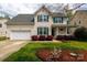 Charming two-story home boasts manicured lawn, landscaping, and welcoming front porch at 1540 Coatsworth Ln, Rock Hill, SC 29732