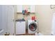 Well-equipped laundry room with modern washer and dryer, plus convenient overhead shelving for storage at 1540 Coatsworth Ln, Rock Hill, SC 29732