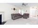 Cozy living room with plaid furniture, a ceiling fan, and neutral carpet at 1540 Coatsworth Ln, Rock Hill, SC 29732