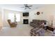 Inviting living room with fireplace, ceiling fan, and plaid sofa, creating a comfortable atmosphere at 1540 Coatsworth Ln, Rock Hill, SC 29732