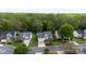 Exterior view of multiple homes with manicured lawns, trees, and driveways on a quiet street at 1540 Coatsworth Ln, Rock Hill, SC 29732