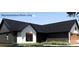Modern farmhouse showing the dark paint of the siding and the contrasting light wood of the window frames at 169 Hickory Grove Rd, Harmony, NC 28634