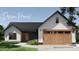 Charming modern farmhouse exterior featuring a welcoming entrance and stylish garage door at 169 Hickory Grove Rd, Harmony, NC 28634