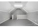 Bright, finished attic space with white walls, gray flooring, and sloped ceilings at 17315 Langston Dr, Charlotte, NC 28278