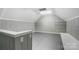 Spacious attic with painted paneling, gray flooring, and ample storage shelves at 17315 Langston Dr, Charlotte, NC 28278