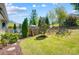 Backyard with a charming outdoor kitchen with a pizza oven and an outdoor entertaining space at 17315 Langston Dr, Charlotte, NC 28278
