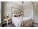 Charming bedroom with a floral four-poster bed, side table, and round mirror at 17315 Langston Dr, Charlotte, NC 28278